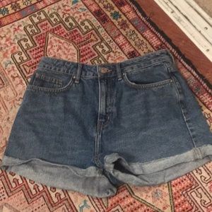 High waisted, medium wash denim shorts.